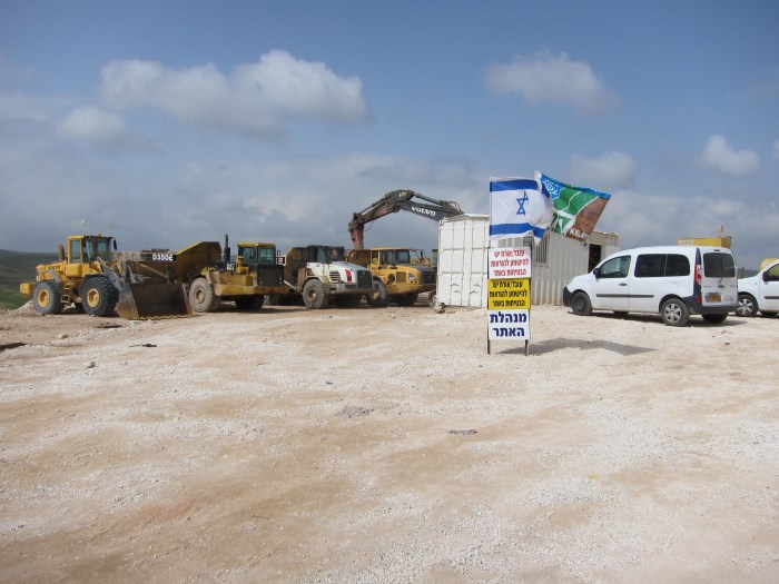 Bulldozers set to demolish Palestinian Bedouin village of Um El Heran, Al-Naqab desert. The village is to be destroyed in preparation for the construction of a Zionist settlement.  The Jewish National Fund (JNF) flag flies alongside the Israeli flag.  
